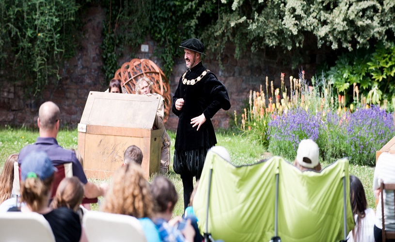 Actor performing outdoors in GB Theatre's Twelfth Night 